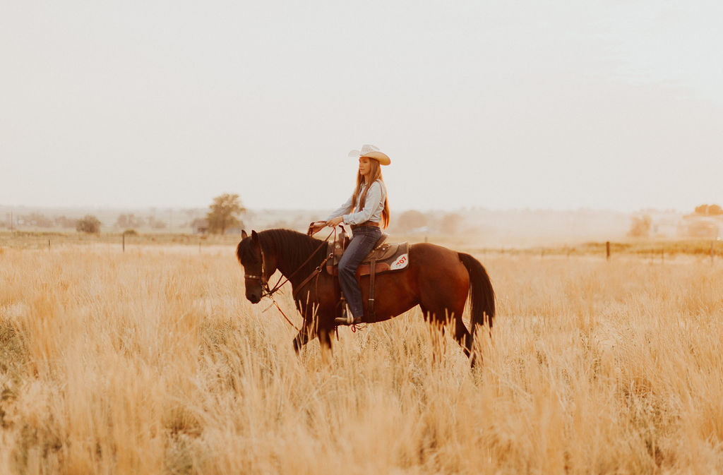 woman wearing cowboy hat riding a horse as she teaches blog content strategy to students