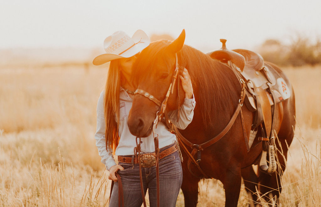 content tips for small businesses from woman with long dark hair wearing a cowboy hat hugging a bay horse